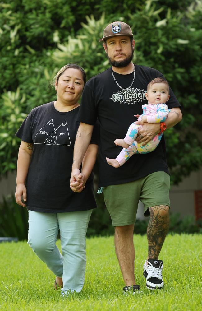 Chie Tanaka and Tarrin Sweeney with one of their twin daughters Cosmo in South Brisbane. Picture: Liam Kidston