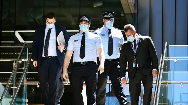 Constable Zachary Schembri (front) &amp; Constable Shane Warren leave the Townsville Courthouse after giving evidence at an inquest. Pictured with Gilshenan &amp; Luton Legal Practice lawyers and Queensland Police Union representative. Picture: Alix Sweeney