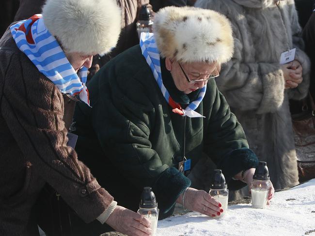 Holocaust survivors light candles at the International Monument to the Victims of Fascism, after a ceremony marking the 72nd anniversary of the liberation of the German Nazi death camp Auschwitz-Birkenau, in Oswiecim, Poland on Friday. Picture: AP Photo/Czarek Sokolowski