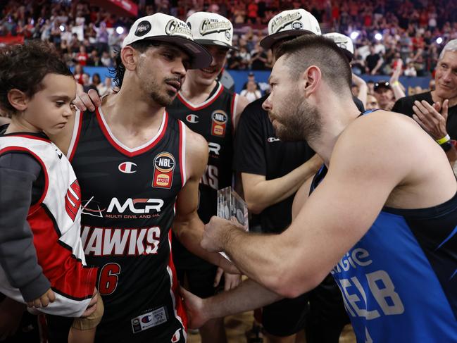 Matthew Dellavedova hands over his Finals MVP award to William Hickey Picture: Darrian Traynor/Getty Images.