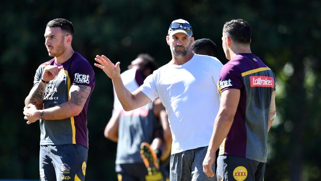 Former Broncos player Peter Ryan (centre) speaks with Darius Boyd (left) and James Roberts (right) during a Brisbane Broncos training session. Picture: AAP Image