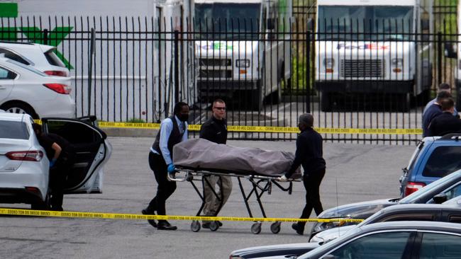 Officials recover a body at the site of a mass shooting at a FedEx facility in Indianapolis, Indiana, on April 16, 2021 where nine people were killed. Picture: Jeff Dean / AFP