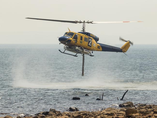 A helicopter at work in Miena in Tasmania’s Central Plateau. Picture: HEATH HOLDEN/Getty Images