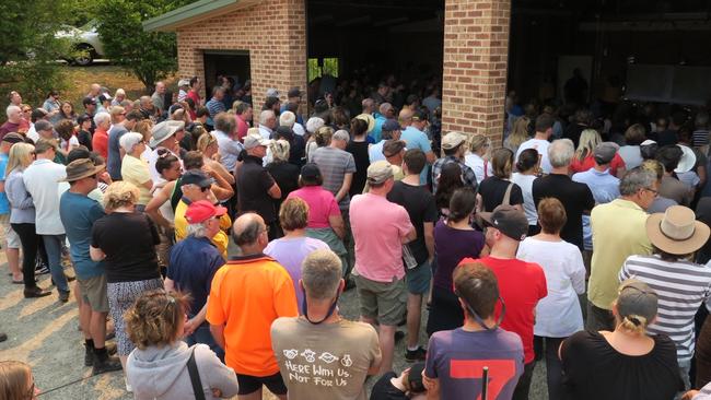 Residents listen to safety advice at a public meeting at Yarramalong RFS station in light of the looming Grospers Mountain fire. Picture: Richard Noone