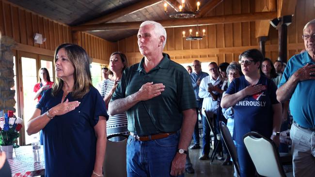 Mike Pence and his wife Karen Pence recite the pledge of allegiance at the Clinton County GOP Hog Roast this week. Picture: AFP