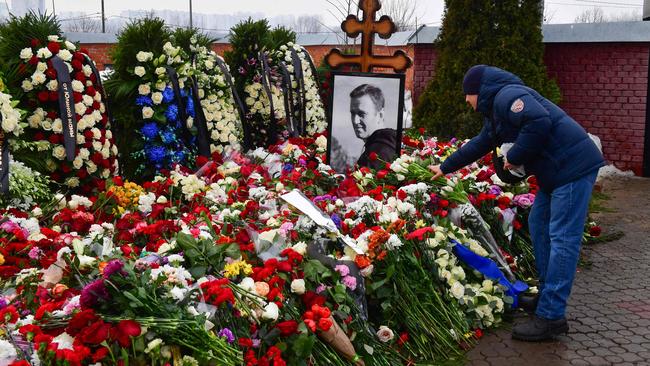 A mourner lays flowers on the grave of Russian opposition leader Alexei Navalny at the Borisovo cemetery in Moscow on March 2, 2024, the day after Navalny's funeral. Picture: Olga Maltseva/AFP