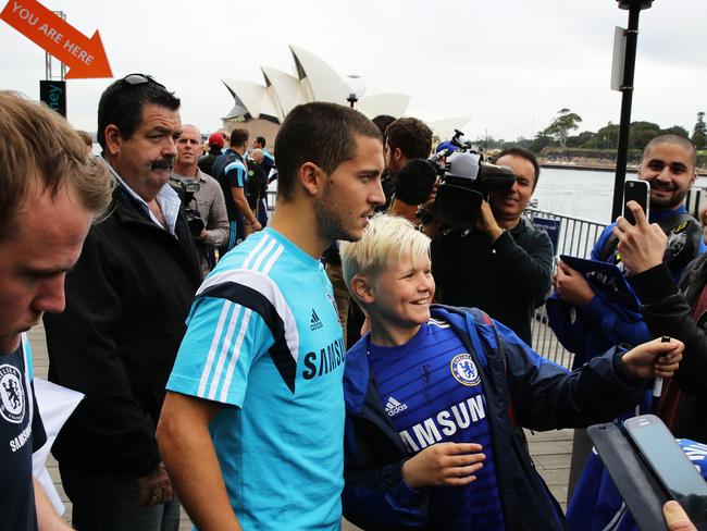 Chelsea star Eden Hazard poses for pictures with fans in Sydney.