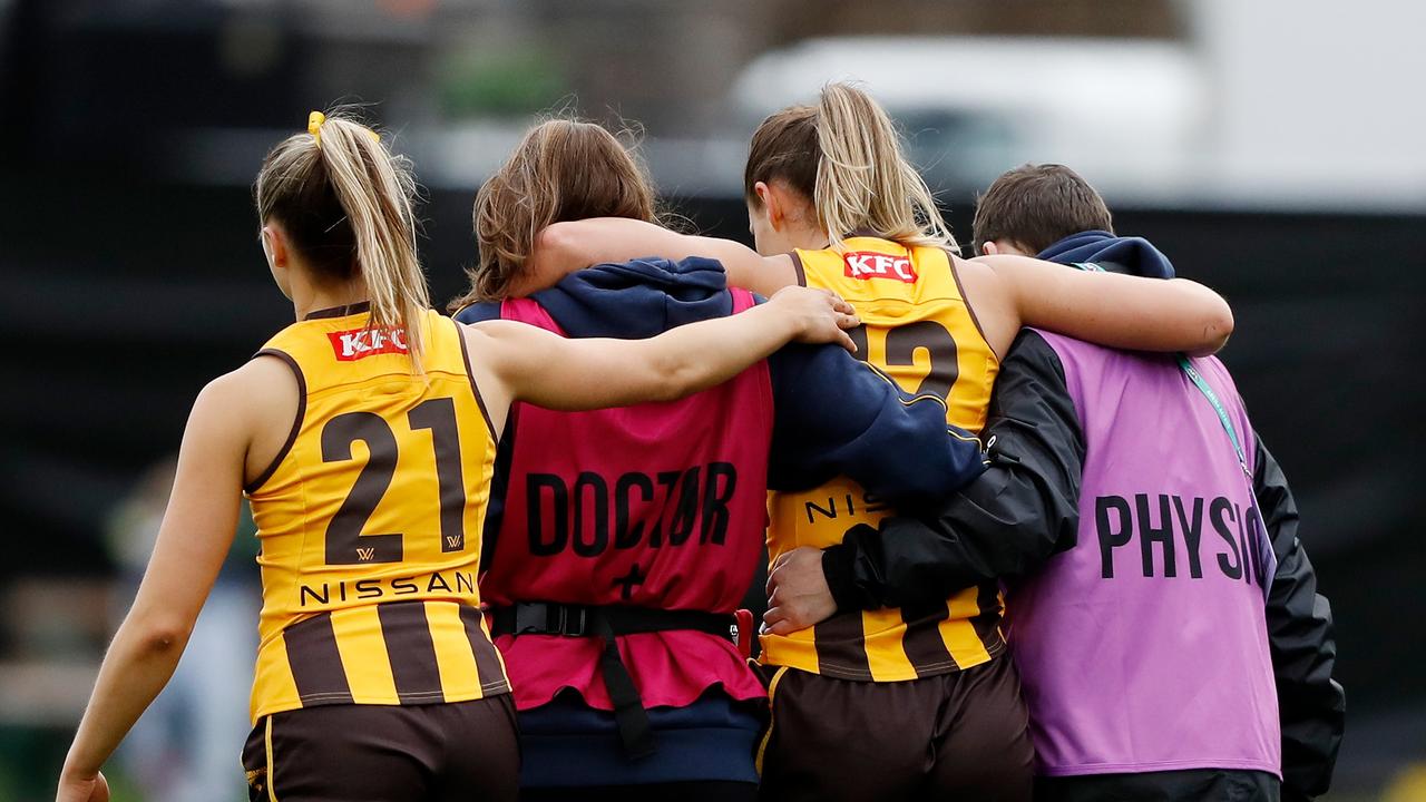 Sophie Locke consoles Louise Stephenson after her injury. Picture: Dylan Burns/AFL Photos via Getty Images