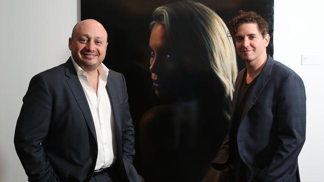 Kestelman and artist Vincent Fantauzzo with the Charlize Theron portrait. Picture: Getty Images