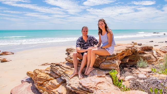 Holidaymakers Joelle Matier and Jonathan Dean soak up the spring sunshine at Cable Beach in Broome on Tuesday, after their overseas travel plans were scuppered. Picture: Abby Murray