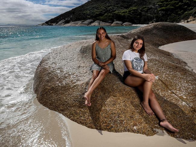 10/02/2019Janaya Colbung, 15 (green dress), and Tayla Winmar, 17, at Little Beach, Albany,  want to finish Year 12 in their idyllic south coast home of Albany and go to university.