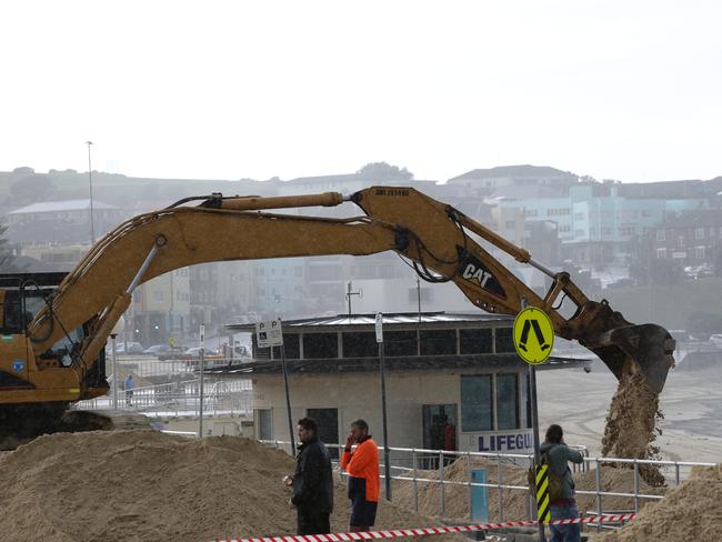Clean up of sand at Bondi Beach after wild storms. Picture: Craig Wilson