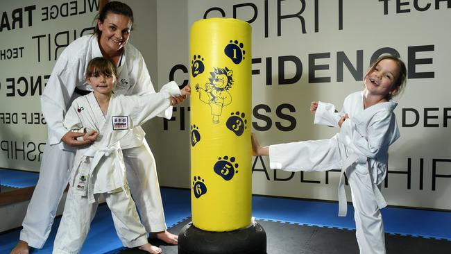 Karate champion Michelle Wilson juggles full-time work and a demanding competition schedule with caring for twin daughters, Ryleigh and Layla. Picture: Tom Huntley