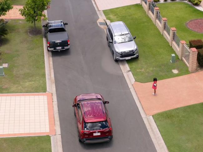 Image from a Logan council video urging residents to park with two wheels up in narrow streets.