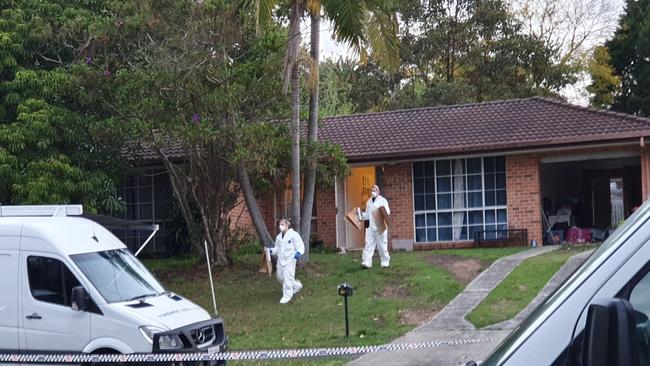 Investigators walk from the house being examined in relation to the murder of Danielle Easey with bags. Picture: Fiona Killman