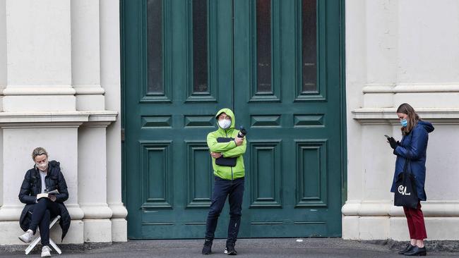 People line up at the Royal Exhibition Building in Melbourne to get their vaccine jab on Tuesday. Picture: Ian Currie