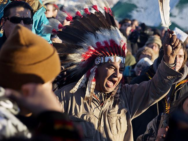 A crowd gathers in celebration at the Oceti Sakowin camp after it was announced that the U.S. Army Corps of Engineers won't grant easement for the Dakota Access oil pipeline in Cannon Ball, N.D., Sunday, Dec. 4, 2016. (AP Photo/David Goldman)