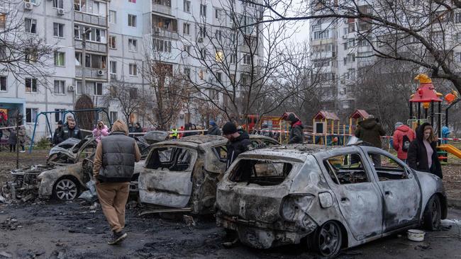 Locals inspect burnt-out cars in the courtyard of a residential building following a missile attack in Odessa on January 28. Picture: Oleksandr Gimanov / AFP