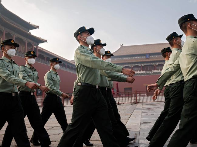 (FILES) In this file photo taken on May 21, 2020 People's Liberation Army (PLA) soldiers march next to the entrance to the Forbidden City during the opening ceremony of the Chinese People's Political Consultative Conference (CPPCC) in Beijing. - The Chinese military is pressing to double its 200-plus nuclear warheads within a decade with the ability to launch them aboard ballistic missiles by land, sea and air, the Pentagon said in a report September 1, 2020. (Photo by NICOLAS ASFOURI / AFP)