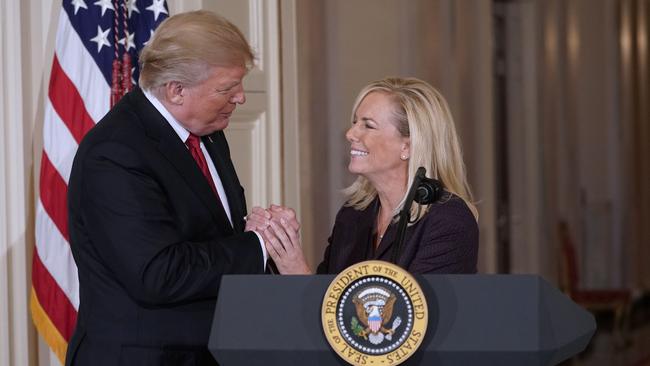 US President Donald Trump clasps hands with Kirstjen Nielsen after nominating her to be Homeland Security Secretary in the East Room of the White House in Washington.