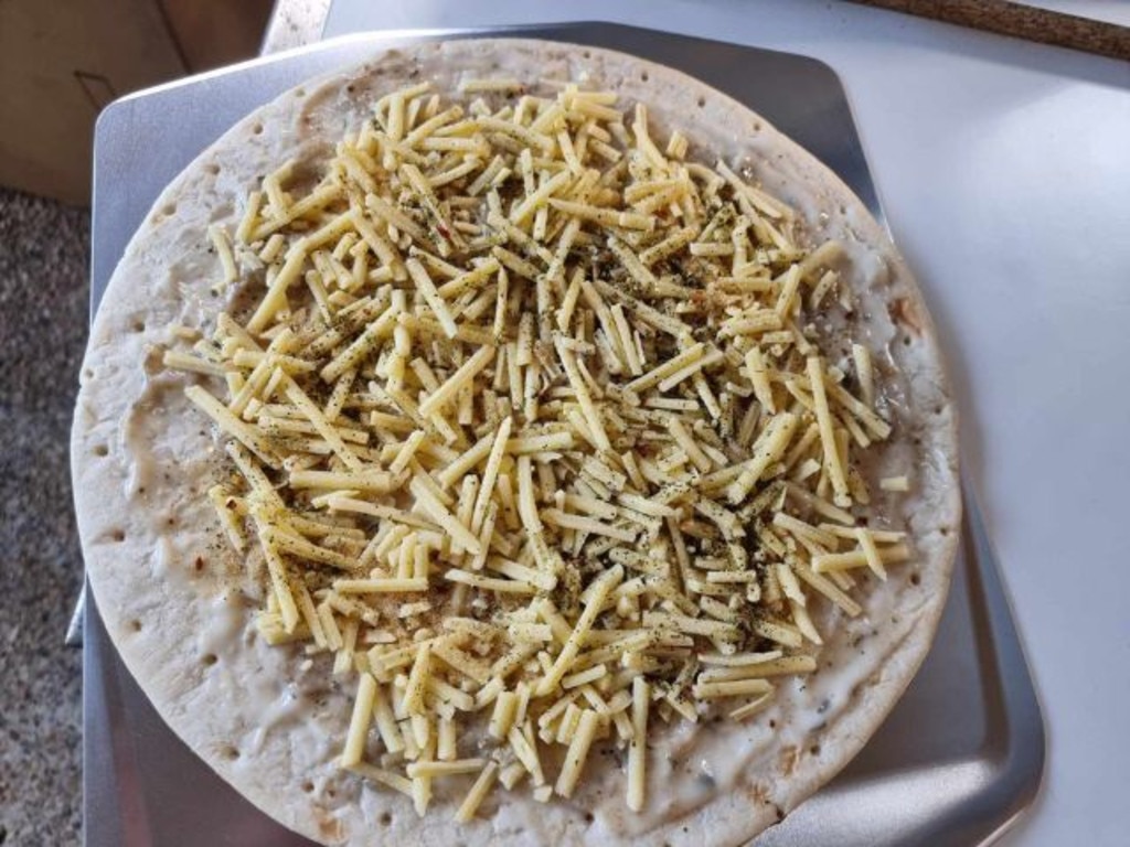 Getting ready to put truffle pizza into the Ooni multi-fuel oven. Picture: Tahnee-Jae Lopez-Vito/news.com.au.