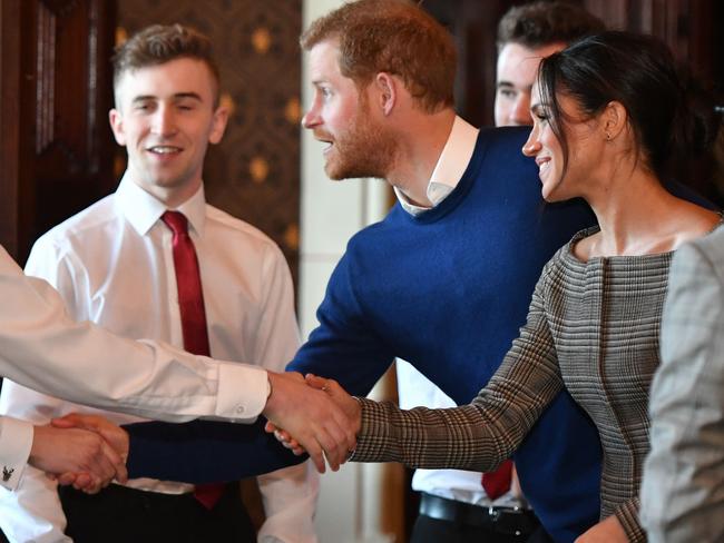 Britain’s Prince Harry and fiancée Meghan Markle greet performers during a visit to Cardiff Castle in Cardiff, south Wales on January 18, 2018, for a day showcasing the rich culture and heritage of Wales. Picture: AFP