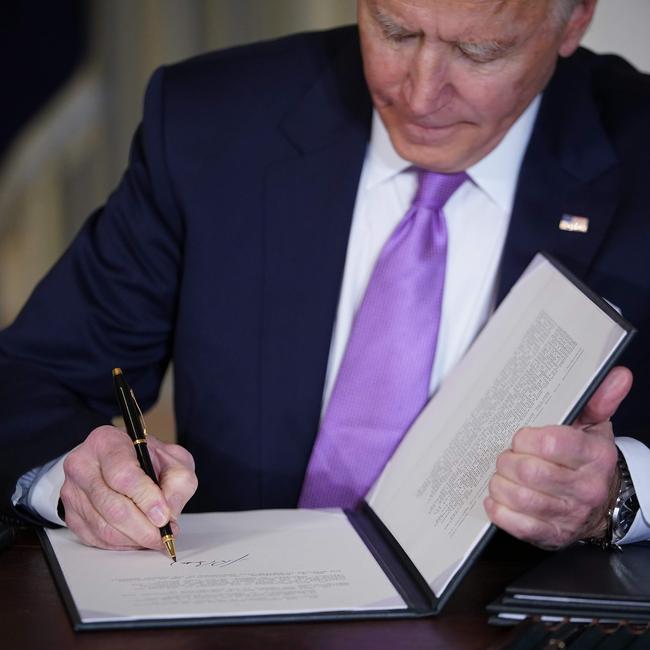 Mr Biden signs executive orders after speaking on racial equity in the White House State Dining Room. Picture: AFP