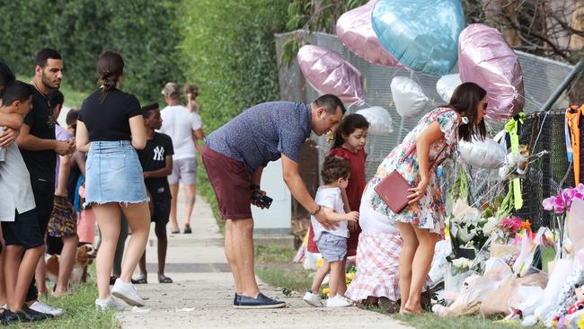 Mourners leave flowers at the scene of the fatal crash. Picture: David Swift