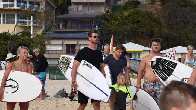 Chris Hemsworth joined locals to honour the memory of Currumbin Vikings Surf Club president John Munro at Currumbin Beach on Saturday.