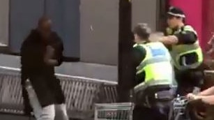 The attacker clutches his chest in the split second after a police officer opens fire to bring the Bourke Street carnage to an end.