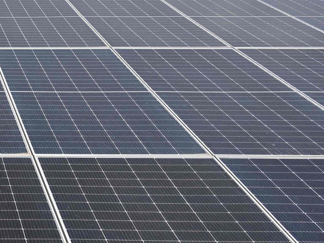 Franck Alain Yayo, operations engineer of the photovoltaic solar power plant, looks at the photovoltaic panels at the Boundiali solar power plant in Boundiali on May 22, 2024. (Photo by Sia KAMBOU / AFP)