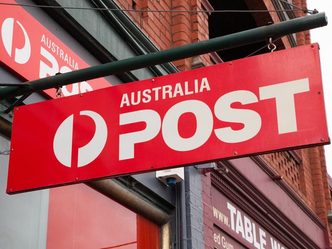 Melbourne, Australia - December 7, 2014: Australia Post is the national supplier of postal services in Australia. This is the Australia Post sign hanging outside a street front store in Hawthorn, Melbourne, Australia.