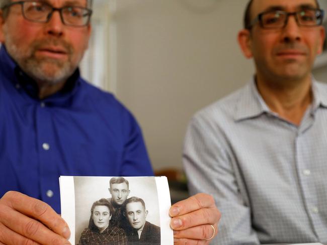 Brothers Eli and Saul Lieberman show a photograph of their late father Joseph, a survivor of the Nazi death camp Auschwitz, taken several years after the Holocaust. Picture: Reuters/Ronen Zvulun