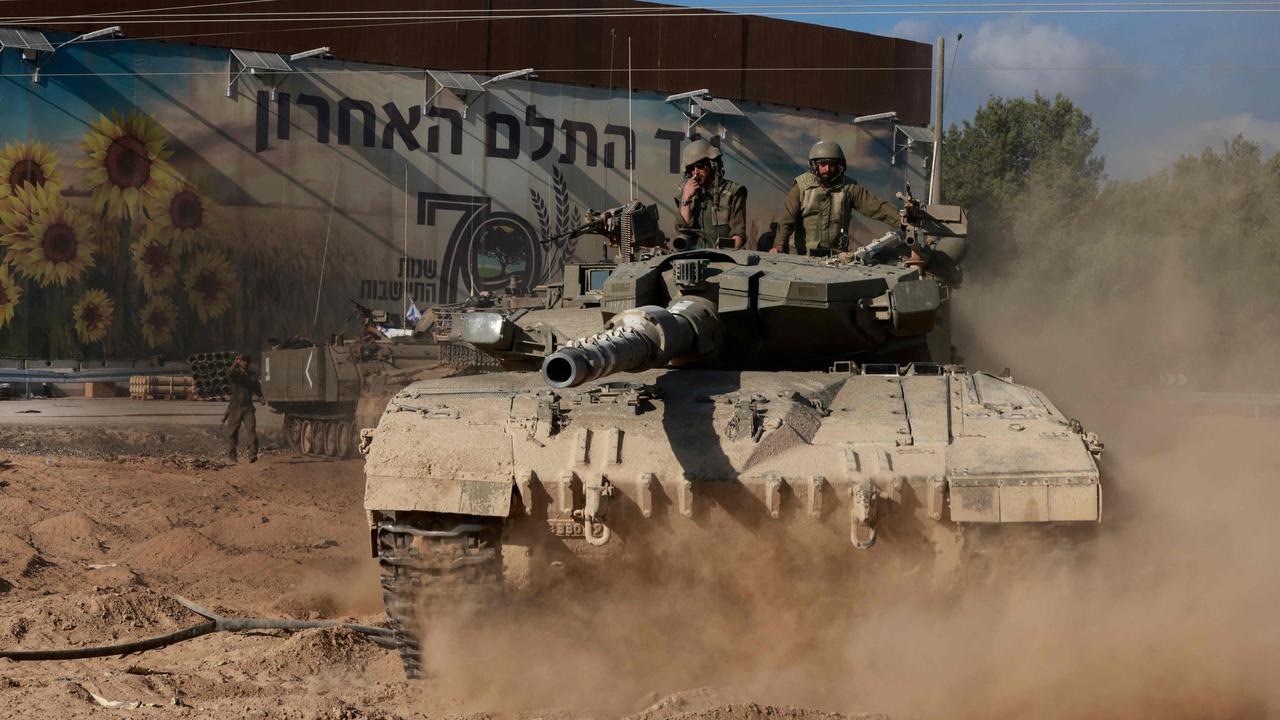 Israeli troops maneuver a tank near kibbutz Nahal Oz on the border with the Gaza Strip. Picture: AFP