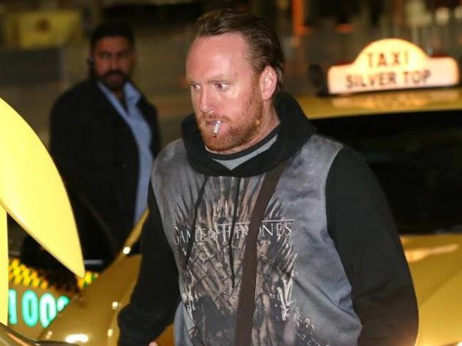 Mark Rossiter heads to a waiting taxi after landing back in Melbourne. Picture: Ian Currie