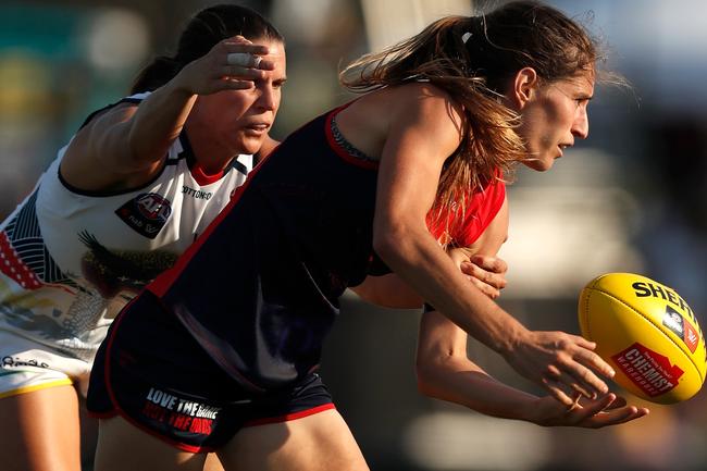 Melbourne’s Catherine Phillips is about to be tackled by Adelaide’s Chelsea Randall at Casey Fields in Melbourne.