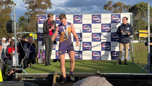 Connor Menadue walks off stage after winning the medal.