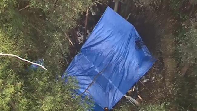 Tarp cover the downed Microflite helicopter at Mt Disappointment. Picture: Nine News