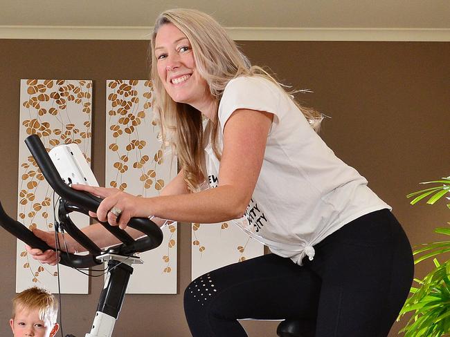 Kidsafe story about gym equipment accidents at home involving kids. Mum Jenny Newton with gym equipment and her three children from left : Jack, 9, Ava, 6 and Leo, 4, who can't play on the equipment.Picture : Nicki Connolly