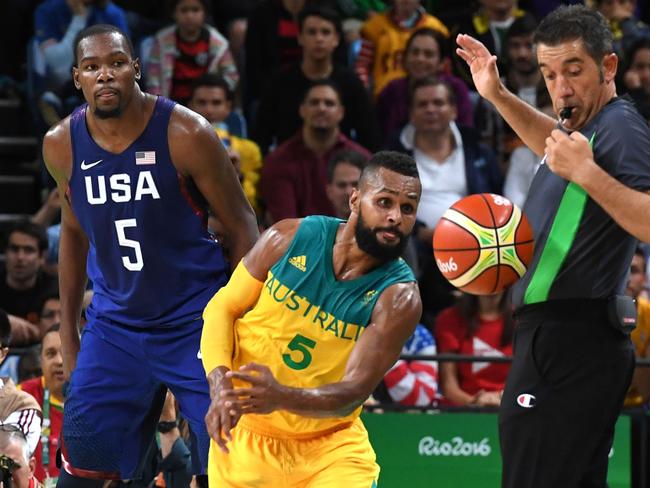 Australia's guard Patty Mills (C) and Team USA’s Kevin Durant (L).