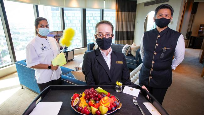 Bell attendant The Quach, Food and Beverage Supervisor Tabatha Tennings and Room Attendant Amreen Turki welcome customers back to Crown Tower. Picture: Mark Stewart