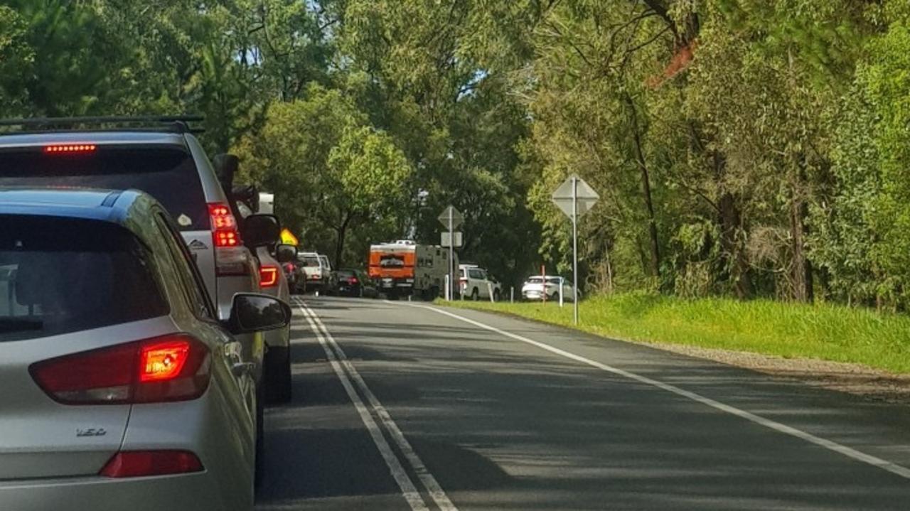 Cars stopped on Sunshine Coast roads due to flooding.