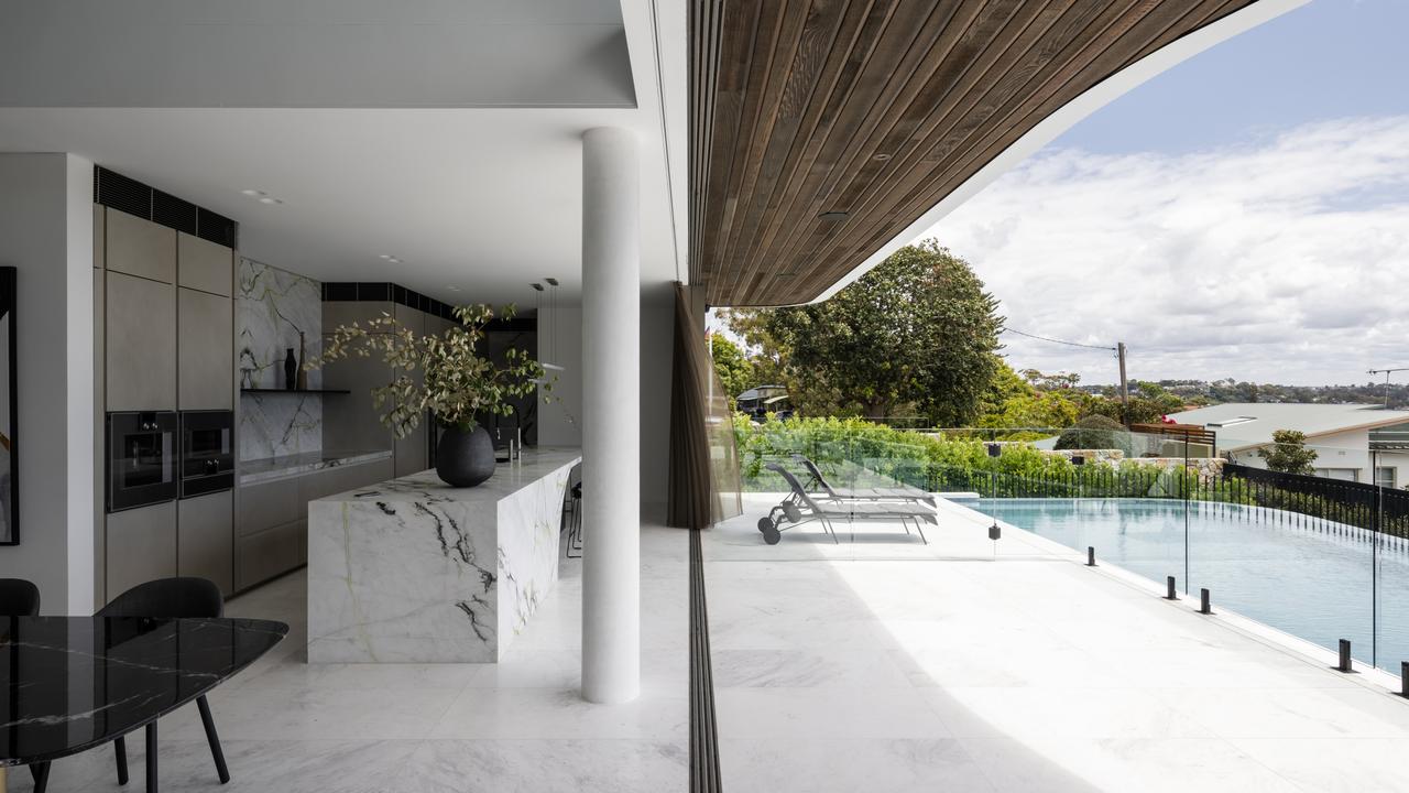 The kitchen opens to the pool.