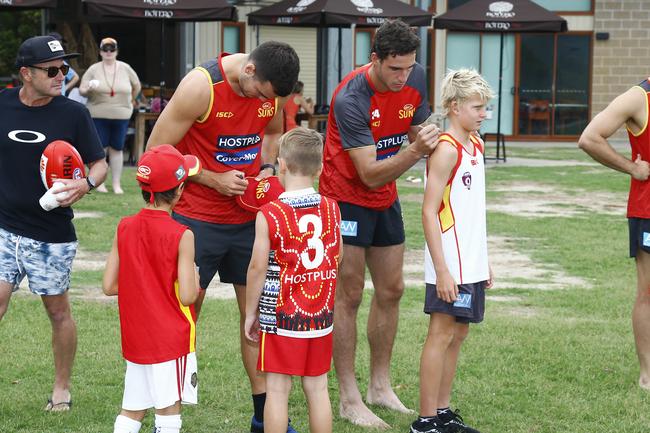 Gold Coast Suns players Jack Bowes (left) and Ben King (right) with fans at Palm Beach. Picture: Tertius Pickard