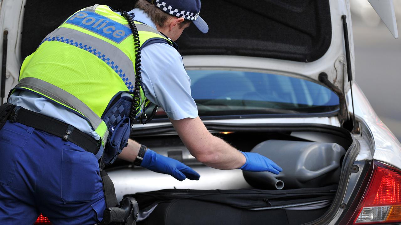 Generic and stock images around Melbourne CBD. Police search a car boot in the city streets.