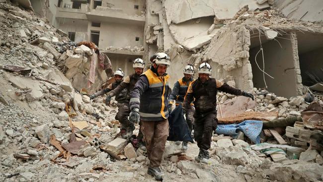 Rescue workers known as the White Helmets carry away the body of a victim found amid the rubble of a building, hit during an air strike by pro-regime forces on the rebel-held town of Ariha in the northern countryside of Syria's Idlib province, on February 5, 2020. Picture: Omar Haj Kadour / AFP