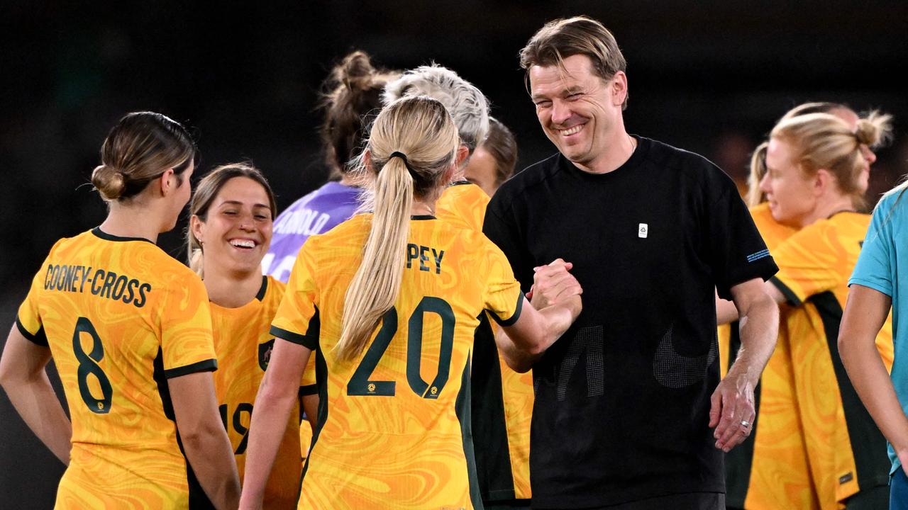 Matildas coach Tony Gustavsson celebrates Olympic Games qualification with his players. Picture: William WEST / AFP