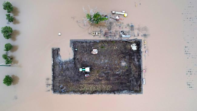 A tractor rests on a small paddock surrounded by floodwater in NSW. Picture: Dan Peled/Getty Images