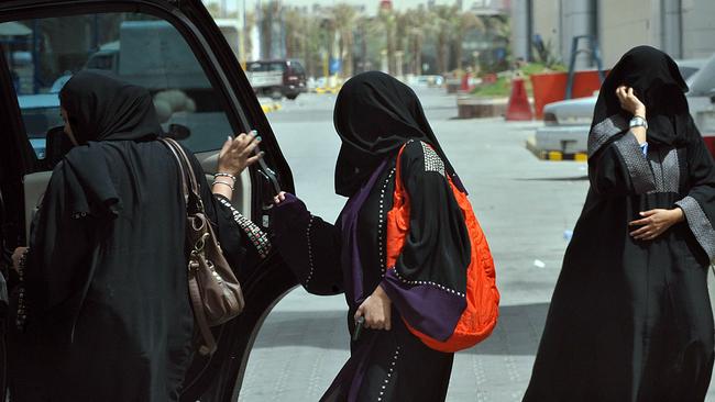 Saudi women get into the backseat of a car. Picture: AFP Photo/Fayez Nureldine