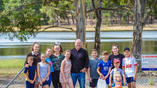 Stephen Ross (centre) and nearby residents say a reopened Hope Valley Reservoir would be a popular tourist destination. Picture: AAP/Roy Vandervegt.